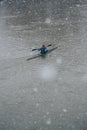 Man in canoe on a snowy Sunday morning on the river Thames