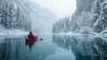 Man canoeing on semi-frozen lake, winter scene, tranquil, icy waters, intimate adventure