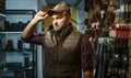 Man in cap, gun shop interior on background Royalty Free Stock Photo