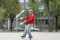 A man in a cap juggles with clubs