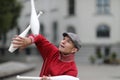 A man in a cap juggles with clubs