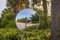 Man captures his reflection in convex traffic safety mirror against backdrop of Walking Street, also known as Red Trail Royalty Free Stock Photo