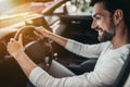 Man in car dealership, Sitting behind the wheel