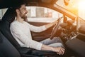 Man in car dealership, Sitting behind the wheel