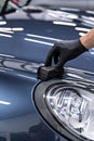 Man car detailing studio worker applying ceramic coating Royalty Free Stock Photo