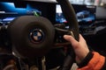man in car driving BMW i5 eDrive40, digital panel, Interior, cockpit modern EV, male hands on steering wheel, driving safety,