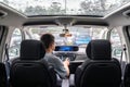 Man in car using touchscreen during rain. Modern car technology inside vehicle. Royalty Free Stock Photo