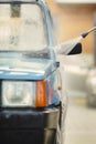 Oldtimer car enthusiast washing his small car by water Royalty Free Stock Photo