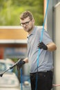 Oldtimer car enthusiast washing his small car by water Royalty Free Stock Photo