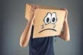 Man with cardboard box on his head and sad face expression Royalty Free Stock Photo