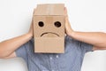 a man with a cardboard box on his head, a sad smiley