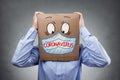 Man with cardboard box on his head wearing a protective face mask for coronavirus or covid-19 Royalty Free Stock Photo