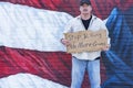 Man with cardboard sign, Stop Killing No More Guns, with American Flag, Royalty Free Stock Photo