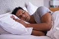 Man, care and sleeping in bed in morning, tired and peace rest on soft pillow with comfortable mattress. Healthy person Royalty Free Stock Photo