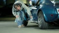 Man carefully polishing the side part of Corvette car