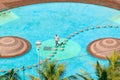 Man carefully walking on stepping stones through water pool in Durban, South Africa