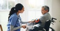 Man, caregiver and senior in wheelchair for blood pressure, monitoring or elderly care at old age home. doctor or