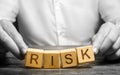 The man carelessly raises the word Risk. Caution and anticipation of possible problems and shocks. Planning and action strategy Royalty Free Stock Photo