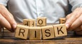 The man carelessly raises the word Risk. High risks in business, fragile balance and insecurity. Caution and anticipation