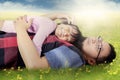 Man caress his daughter on meadow