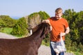 Man caressing and feed a wild donkey Royalty Free Stock Photo