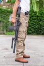 Man in cargo pants with gun Royalty Free Stock Photo