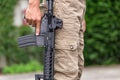 Man in cargo pants with gun Royalty Free Stock Photo