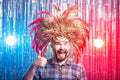 Fun, holiday and april fools day people concept - Strange man with carnival mask and hat Royalty Free Stock Photo