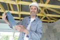 man carpenter holding clipboard at construction site Royalty Free Stock Photo