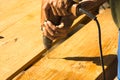 Man carpenter using electric drill on a plank Royalty Free Stock Photo