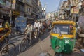 man carries cargo and people with his rickshaw in old Delhi