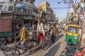 man carries cargo and people with his rickshaw in old Delhi