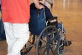The man carries a disabled person in a wheelchair Royalty Free Stock Photo