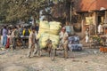 man carries heavy cargo with his rickshaw in old Delhi