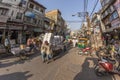 man carries heavy cargo with his wooden cart in old Delhi