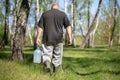 A man carries a jar filled with birch sap Royalty Free Stock Photo