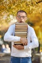 Man carries a lot of books in his hands. A stack of textbooks for training. Preparation for examination Royalty Free Stock Photo