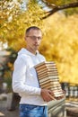 Man carries a lot of books in his hands. A stack of textbooks for training. Preparation for examination Royalty Free Stock Photo