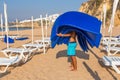 Man carries mattresses on the beach