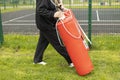 Man carries sports equipment. Preparation of training on street. Equipment for practicing blows