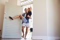 Man Carries Woman Over Threshold Of Honeymoon Rental