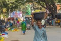 A man carry on the head a basket at a local Indian market