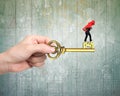 Man carrying arrow up balancing on key in pound sign Royalty Free Stock Photo