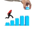 Man carrying arrow up running bar graph block hand building Royalty Free Stock Photo