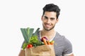 Man carrying a bag full of vegetables Royalty Free Stock Photo