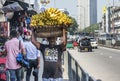 Man carrying basket full of bananas on the street in Colombo town