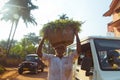 Man carrying basket in her head