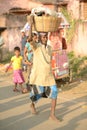 Man carrying basket on his head and walking on the road