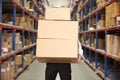 Man Carrying Boxes In Warehouse