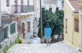 Man Carrying A Boy On His Shoulders Walking Down Steps on Symi, Greece